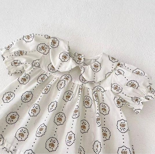 Summer baby romper with round floral patterns
