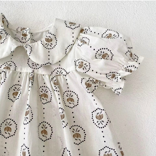 Summer baby romper with round floral patterns